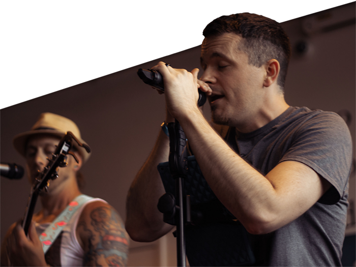 Smoove Series performing live – Mike and Joe on stage delivering high-energy vocals.